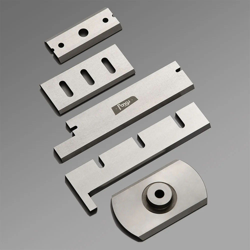 Die cutting blade made of polished steel, featuring various shapes and a mounting hole for secure installation.